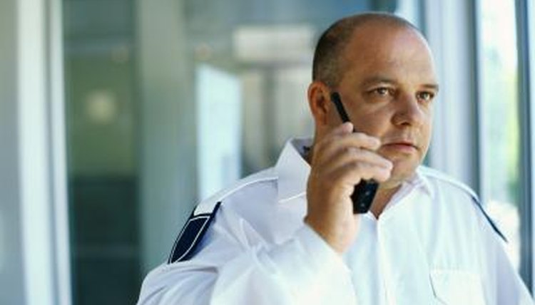 Security guard talking on a walkie talkie.