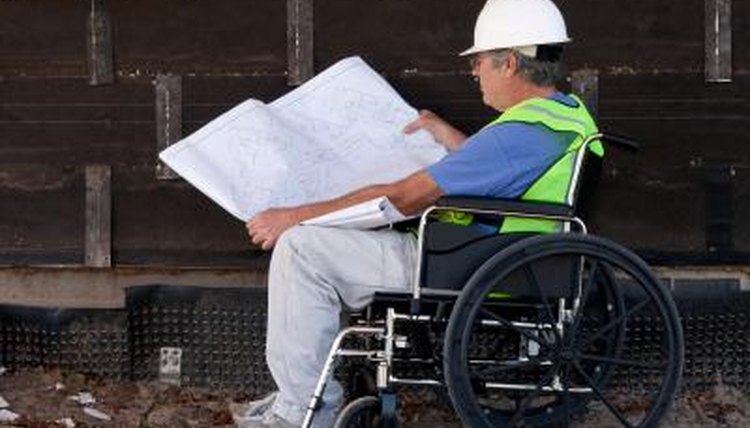 A contractor looks at a blueprint on a job site.