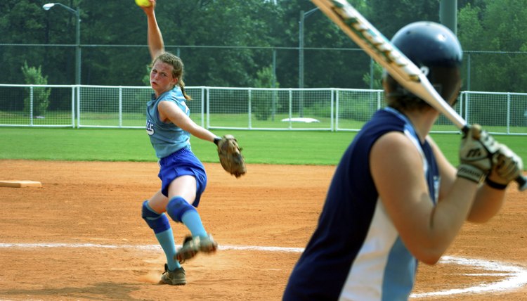 Female Softball Player Pitching To A Batter