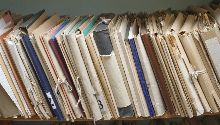 A close-up of a shelf of archived paperwork.