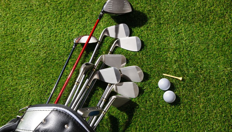 Golf clubs in the bag,balls and tee on grass
