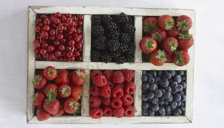 Assorted berry fruits in container, view from above