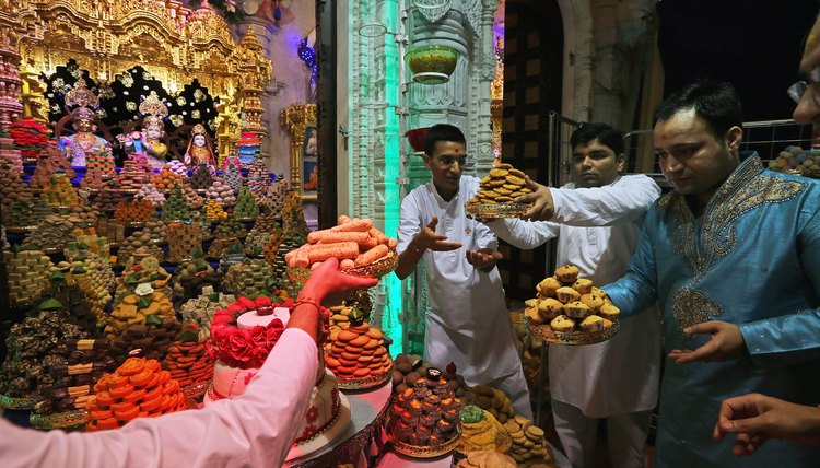 Hindus make offerings to a shrine inside a mandir.