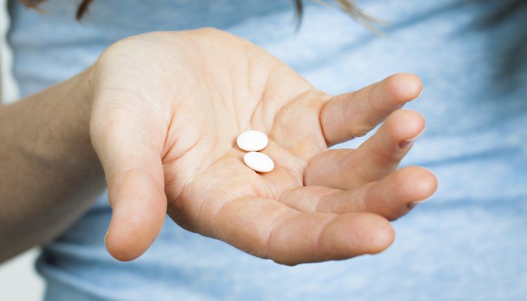 Close-up of hand holding pills