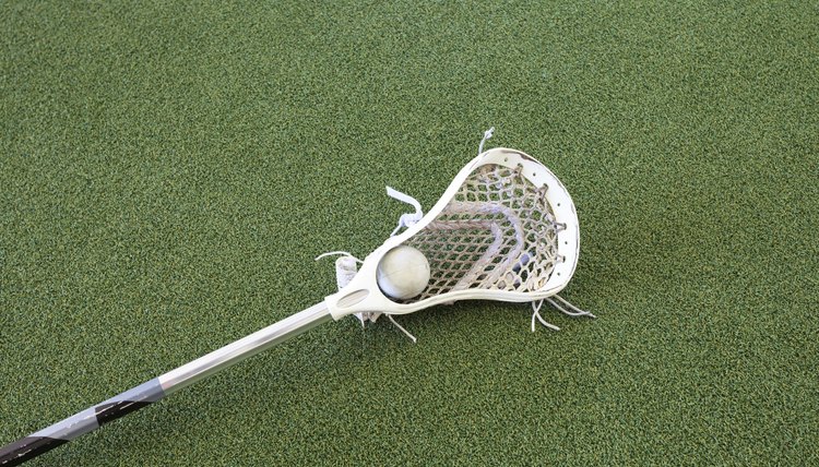 Lacrosse Stick and Ball on Turf