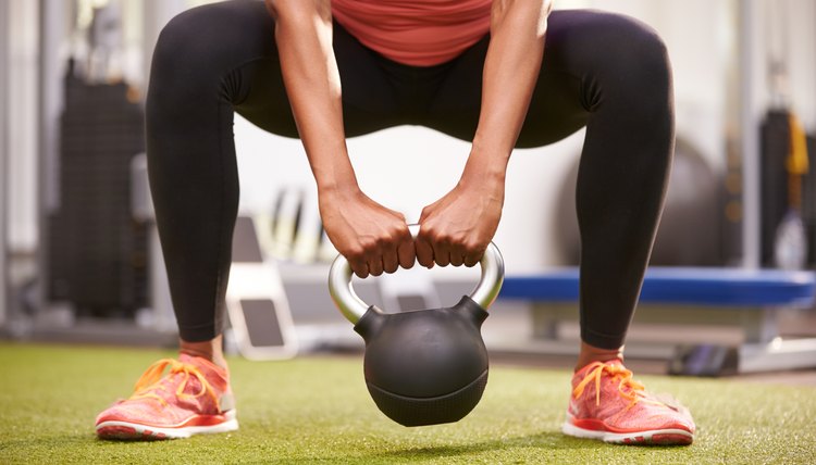 Woman exercising with a kettlebell weight,