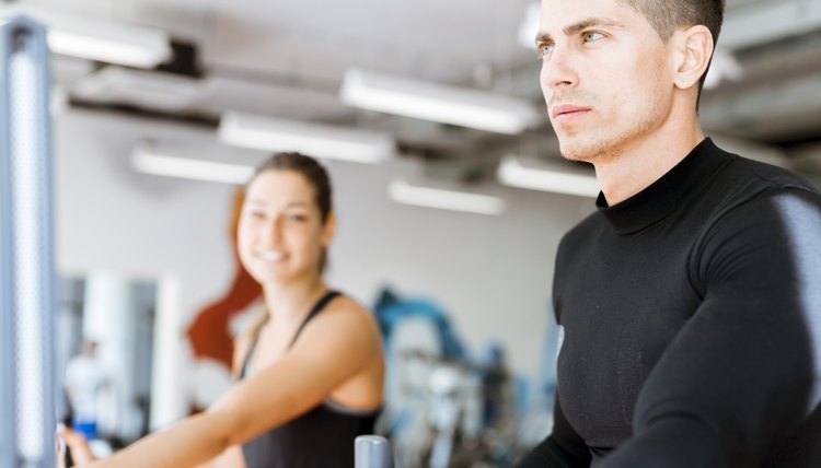 Young group of people working out on a elliptic trainer