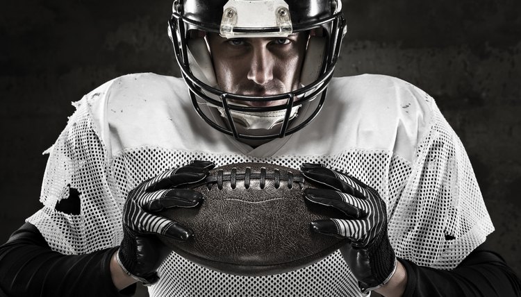 Portrait of american football player holding a ball