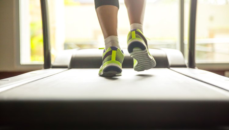 Close up woman running on treadmill