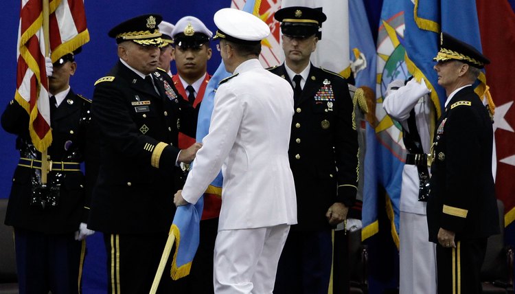 Military officers shaking hands during a ceremony.