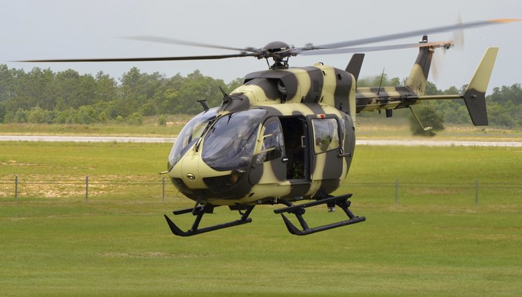 Military helicopter landing on airfield