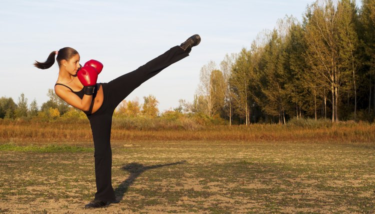 Kick boxing girl exercising in the nature