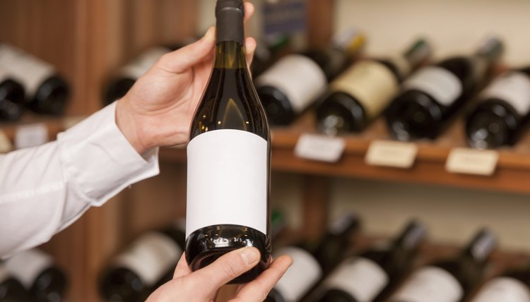 Man holding up nice bottle of wine in store