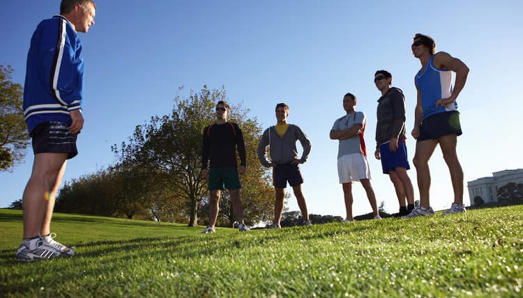 Coach talking to five men in park