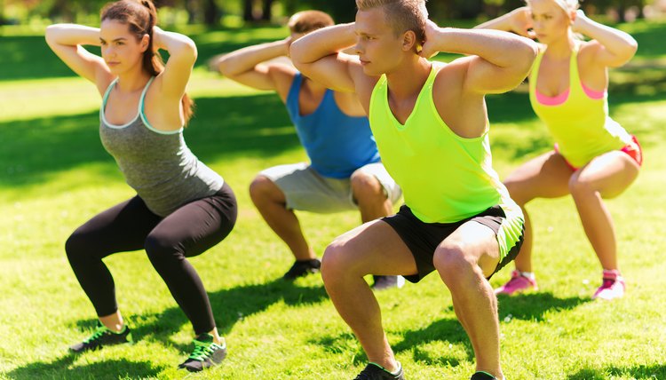 group of friends or sportsmen exercising outdoors