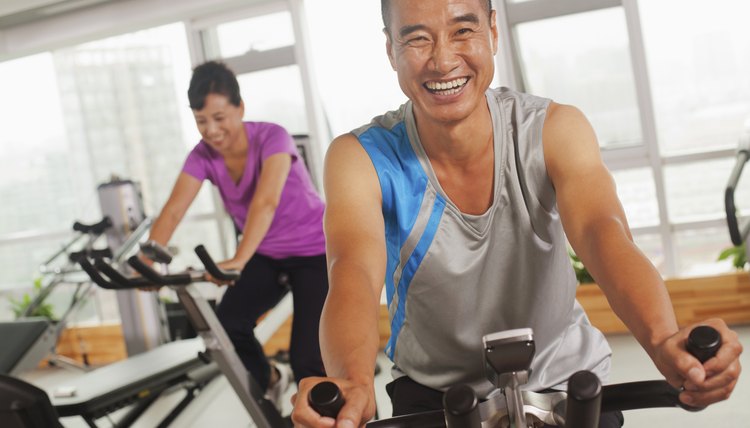 Man smiling and exercising on the exercise bike
