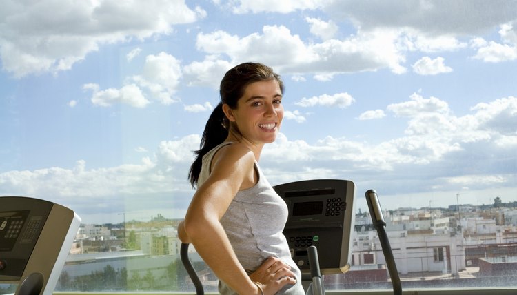 Woman on a cardiovascular machine in front of a window