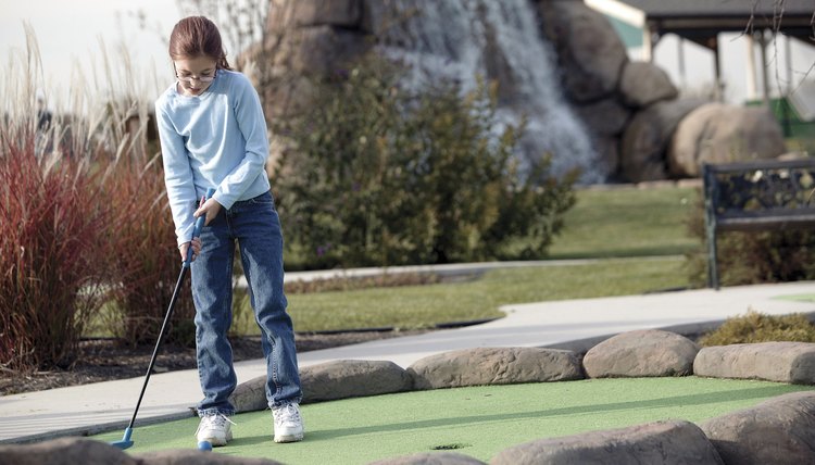 Girl practicing golf