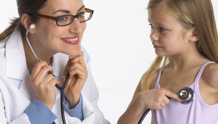 Pediatric residents perform physical exams and give input concerning patient care.
