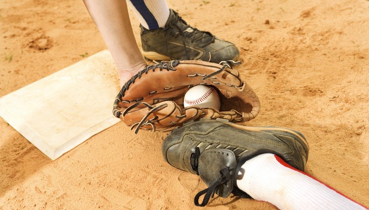 Glove of baseball player tagging runner out