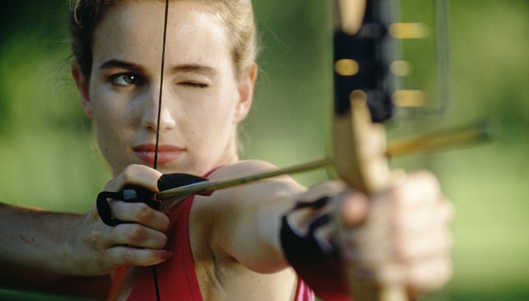 Woman aiming bow and arrow