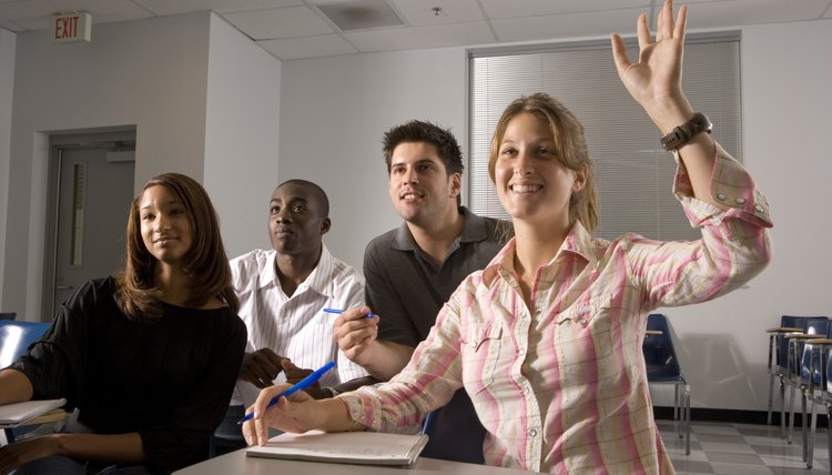 Student raising hand in class.