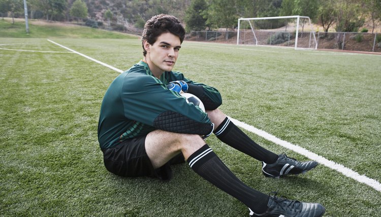 Soccer player sitting on field