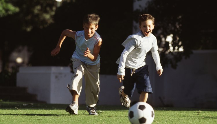 Boys (10-12) playing football