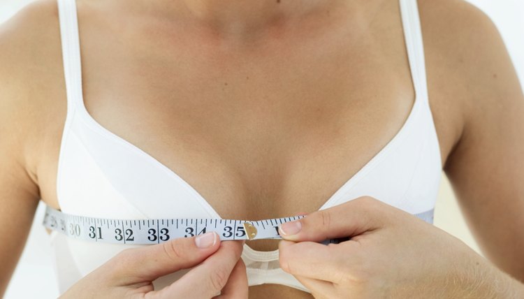 Close-up of a woman measuring her chest with an inch tape