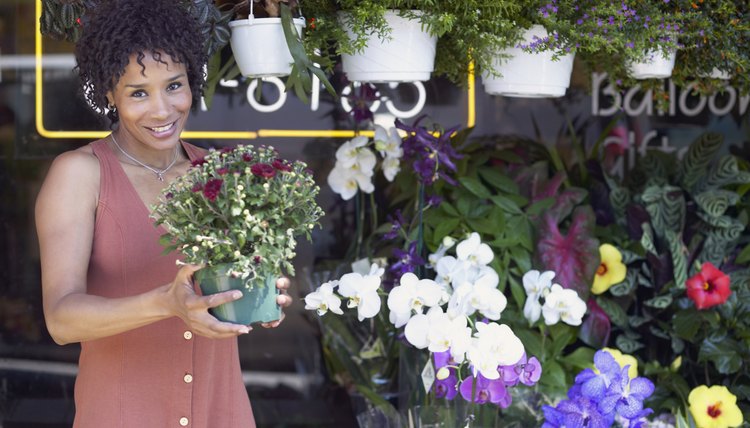 A woman is in her flower shop.