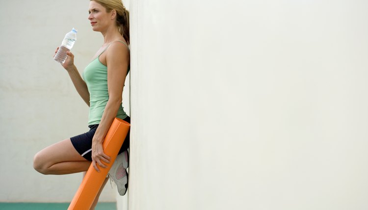 Woman with exercise mat and water bottle