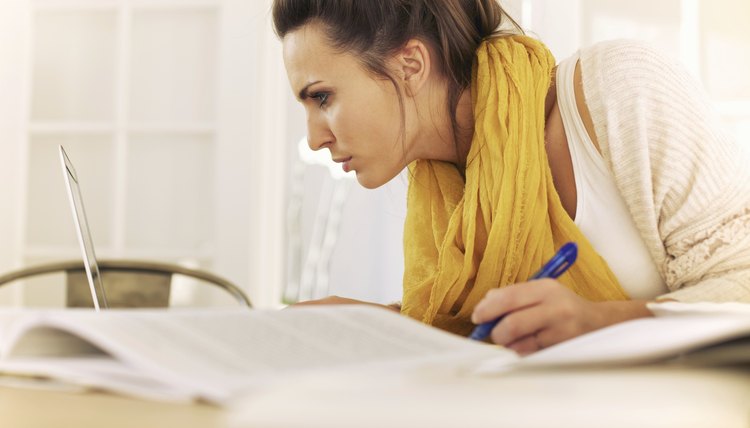 Student with laptop and research