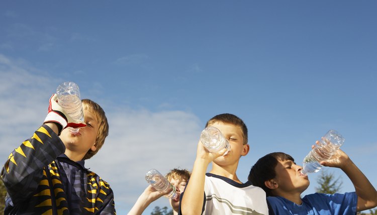 Boys Soccer Team Drinking Water from Bottles