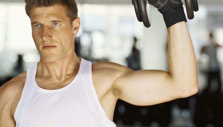 Close-up of a mid adult man exercising in with dumbbells