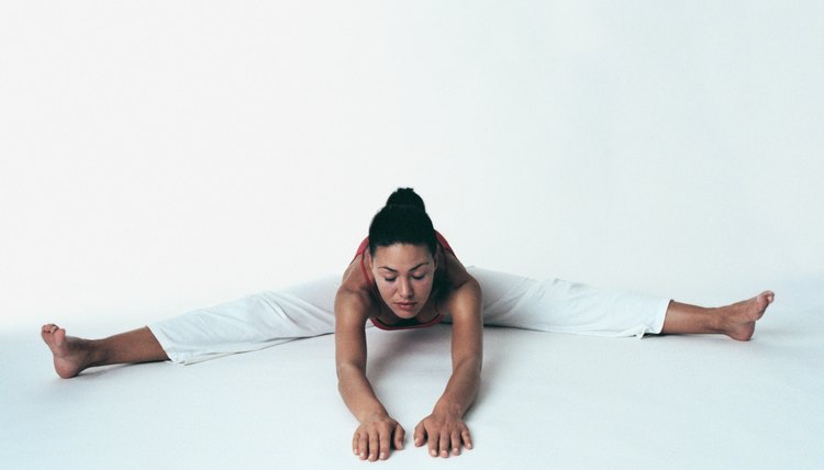 Woman in seated wide-angle forward bend yoga position