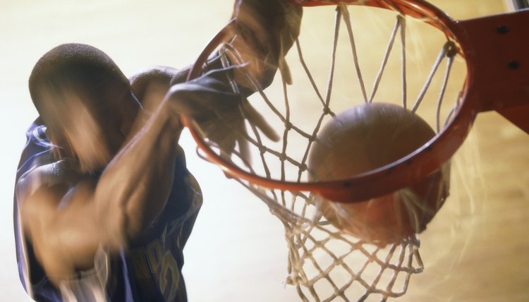 Basketball player slam dunking a ball