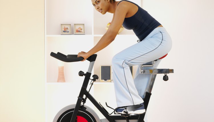 Woman working out on an exercise bike at home