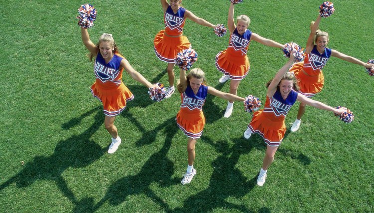 High angle view of a group of cheerleaders cheering in a field