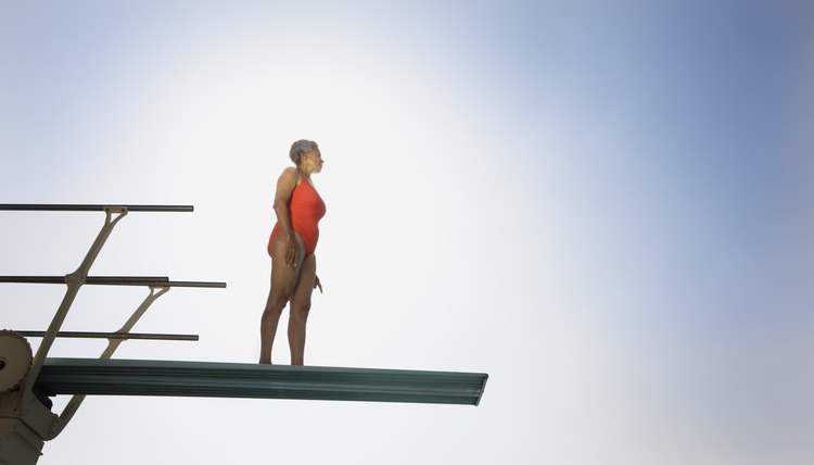 Senior woman on high diving board