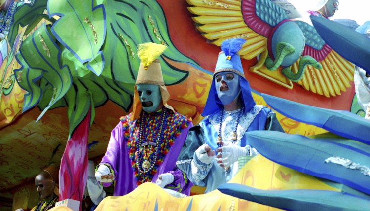 People dressed in costume on a Mardi Gras themed float.