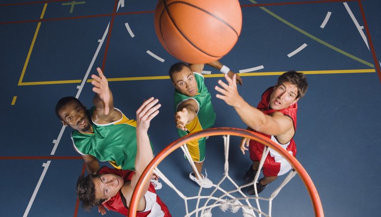 Men jumping for basketball