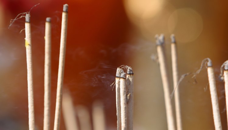 Buddhist incense can take the form of long sticks or granules placed in an incense burner.