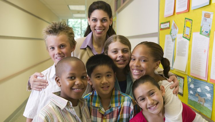 Teacher poses with her students in the hallway