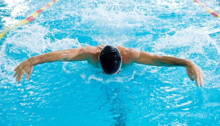 Man swimming butterfly stroke in race