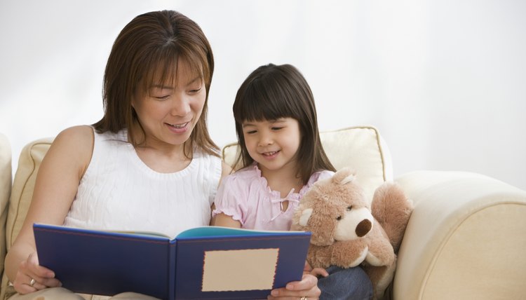 Mother looking at photo book with her daughter