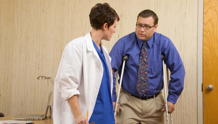Doctor helping a patient with crutches