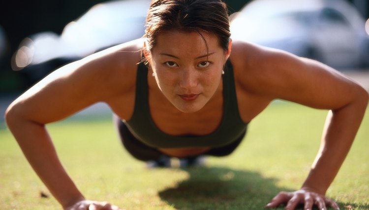 portrait of a young woman doing push ups