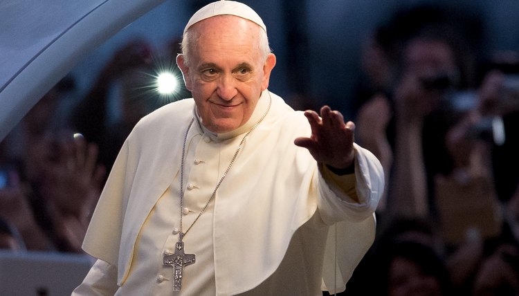 A pope greets a crowd of people.