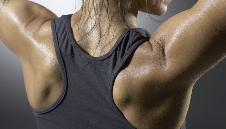 Muscular woman flexing shoulders