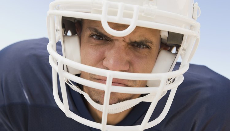 Hispanic male football player wearing helmet